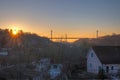 Silhouette of people traveling across bridge