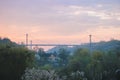 Silhouette of people traveling across bridge