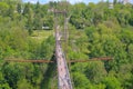 Silhouette of people traveling across bridge