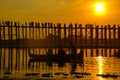 Silhouette of people on U Bein Bridge enjoying wonderful sunset, Mandalay, Myanmar