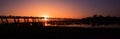 Silhouette of people on U Bein bridge at sunset in Amarapura. Mandalay, Myanmar panorama Royalty Free Stock Photo