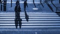 Silhouette people walk on pedestrian crosswalk at the junction s