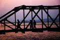 Silhouette people walking across the bridge Royalty Free Stock Photo