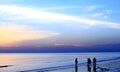 Silhouette people walking along the beach Royalty Free Stock Photo