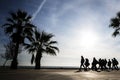 Silhouette of people walking along the promenade