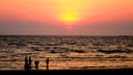 Silhouette people walking in sea with sunset sky Royalty Free Stock Photo