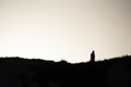 SIlhouette of a people walking at sunset on a hill Royalty Free Stock Photo