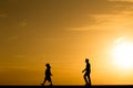 Silhouette people walking at sunset Royalty Free Stock Photo