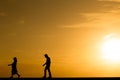 Silhouette people walking at sunset Royalty Free Stock Photo