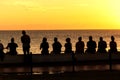 Silhouette of people watching the sunset on the Rio Vermelho beach