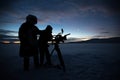 Silhouette of people who filming sunset in desert of Siberia. Royalty Free Stock Photo