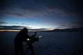 Silhouette of people who filming sunset in desert of Siberia. Royalty Free Stock Photo