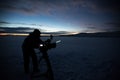 Silhouette of people who filming sunset in desert of Siberia. Royalty Free Stock Photo