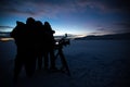 Silhouette of people who filming sunset in desert of Siberia. Royalty Free Stock Photo