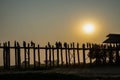 Silhouette of peoples at U-Bein oldes teakwood bridge in the world is made from the remains of a royal palace crossing Taungthaman Royalty Free Stock Photo