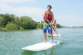 Silhouette perfect couple engage standup paddle boarding