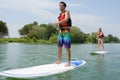 Silhouette perfect couple engage standup paddle boarding