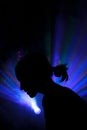 The silhouette of a person in disco rays in the smoke Royalty Free Stock Photo