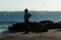 Silhouette of a person enjoying the sea from Porto da Barra in Salvador, Bahia