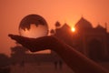 Silhouette of a person holding a glass ball with the reflection of Taj Mahal in India during sunset Royalty Free Stock Photo