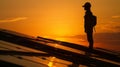 A silhouette of a person installing solar panels on a rooftop representing the individual impact of policy incentives on