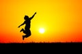 Silhouette of person jumping of joy at Sunset