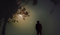 Silhouette of a person. A man is enjoying the beauty of the moon.