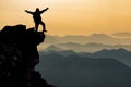 Silhouette of person on mountain peak