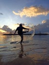 Silhouette of person playing water splash on beach at sunset sunrise. Royalty Free Stock Photo