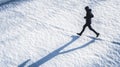 Silhouette of a Person Running on Fresh Snow Royalty Free Stock Photo