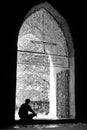 Silhouette of a person sitting in the doorway of a temple ruin in Bagan, Myanmar