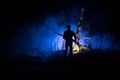 Silhouette of person standing in the dark forest. Horror halloween concept. strange silhouette in a dark spooky forest at night Royalty Free Stock Photo