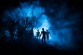 Silhouette of person standing in the dark forest with light. Horror halloween concept Royalty Free Stock Photo