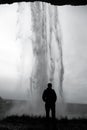 Silhouette of a person standing in front of Seljalandsfoss waterfall near SkÃÂ³gar, Iceland Royalty Free Stock Photo