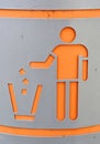 Silhouette of person throwing garbage into a trash can.