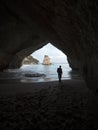 Silhouette of person under archway Cathedral Cove Te Hoho rock Hahei Beach Coromandel Peninsula North Island New Zealand