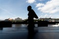 Silhouette of a person walking along the edge of the tourist town of Valenca