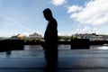 Silhouette of a person walking along the edge of the tourist town of Valenca