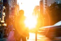 Silhouette of a person walking into the sunset on 14th Street in Manhattan New York City