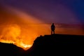 Silhouette of person watching the Kilauea volcano under beautiful starry night sky in Hawaii