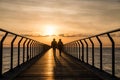 Silhouette of persons waking at Pont Del Petroli at sunrise in Barcelona in Spain