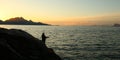 Silhouette photo of fisherman in norwegian sunset