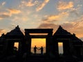 a silhouette photo of a pair of lovers at the gate of a temple called Ratu Boko temple. a cultural tourism area in Yogyakarta