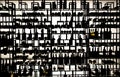 Silhouette photo. Rack with lot of bottles of wine and alcohol at warehouse. Background Wallpaper