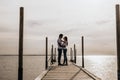 Silhouette photo of romantic couple enjoying sunset harbor view