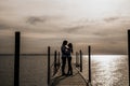 Silhouette photo of romantic couple enjoying sunset harbor view