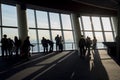 Silhouette photo of tourists in the Tokyo Sjytree dock who are look out through window glasses to see Fuji mountain and Tokyo city