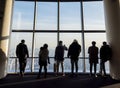 Silhouette photo of tourists in the Tokyo Sjytree dock who are look out through window glasses to see Fuji mountain and Tokyo city