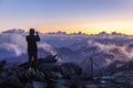 Silhouette of an photographer in the Alps photographing the sunset. View from the way to Grossglockner rock summit, Kals am Royalty Free Stock Photo