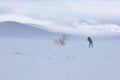 Silhouette of a photographer shooting a snowstorm in the polar tundra